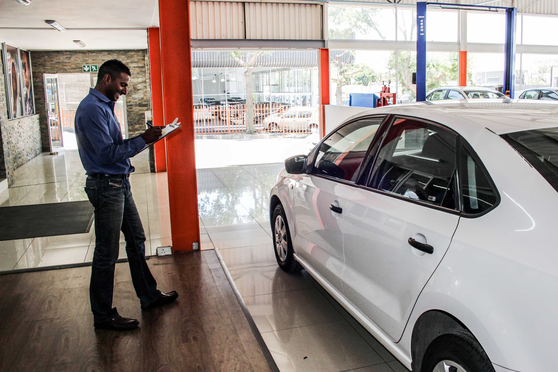 A Body Line service advisor checking in a vehicle at the workshop